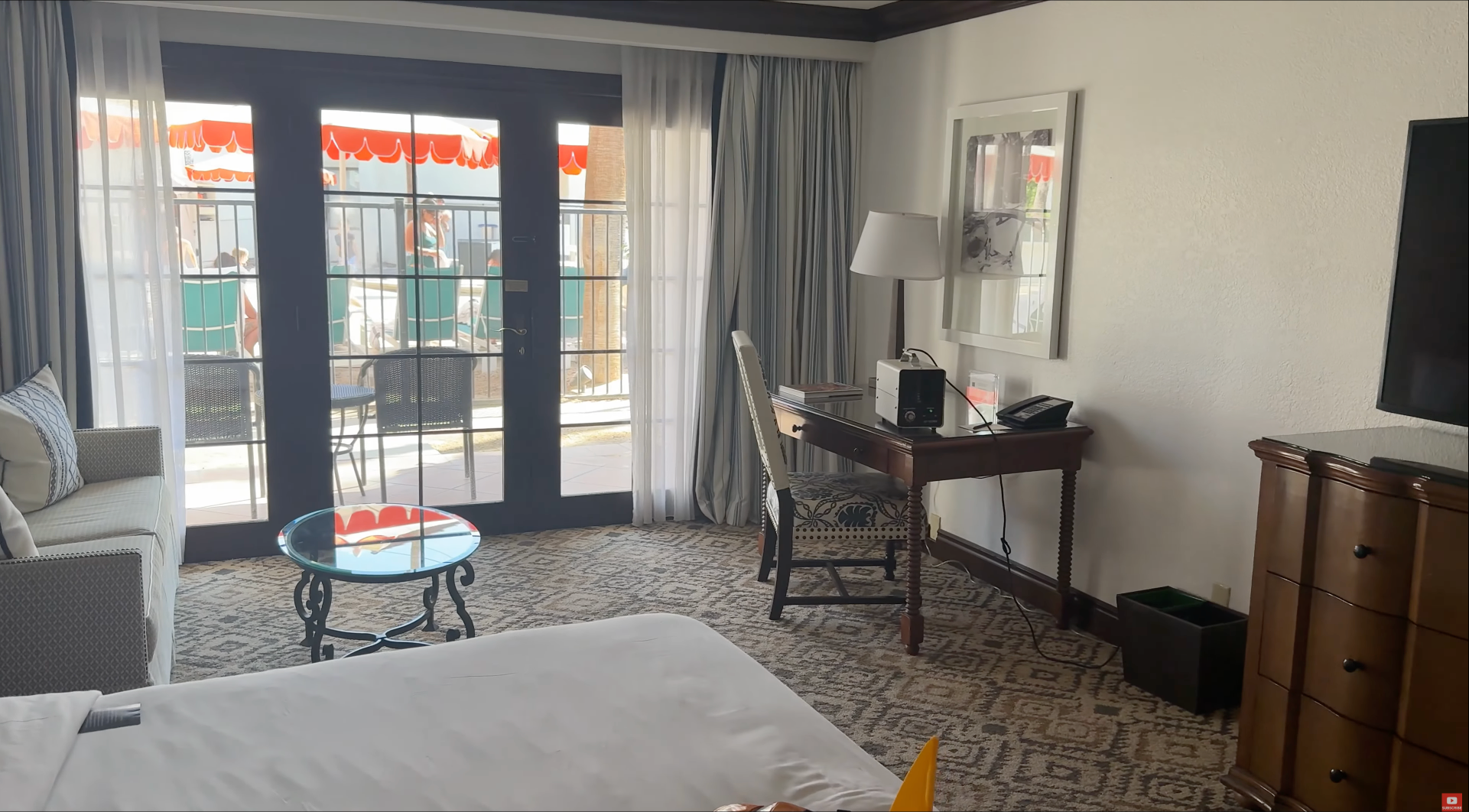 Guest room at the Omni Rancho Las Palmas with a bed, desk and chair, and a white ozone machine running on the desk